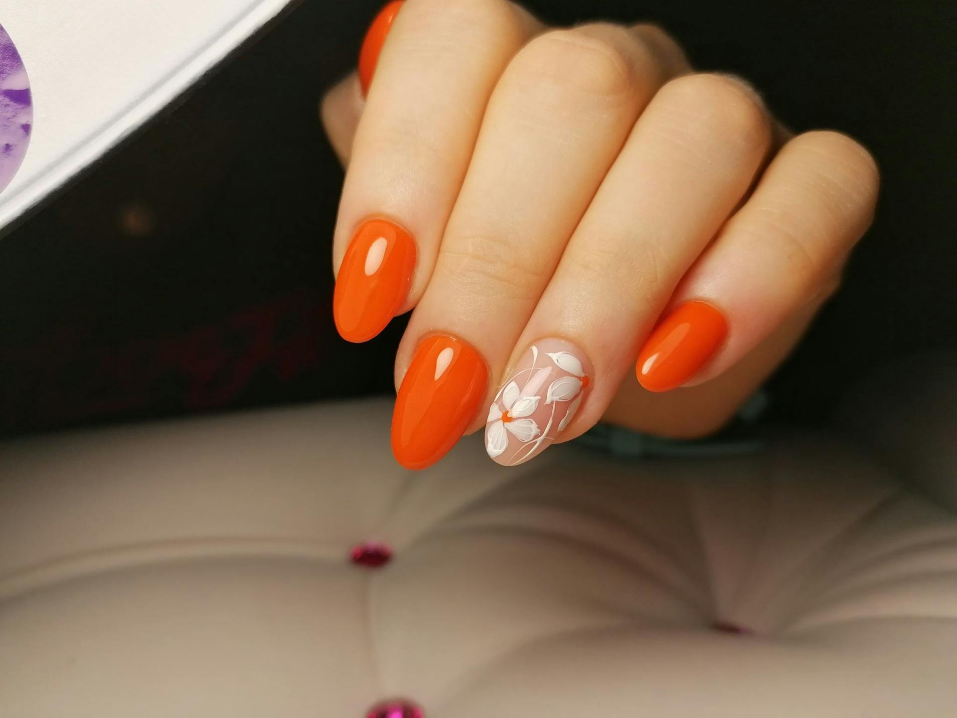 almond nails / radiant orange with white flowers design  